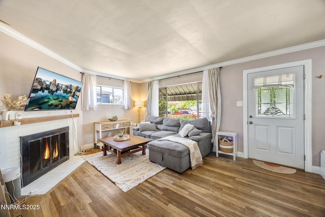 1712 Chaska Pl, Reno, NV 89502 - living area featuring wood finished floors, a lit fireplace, ornamental molding, and baseboards