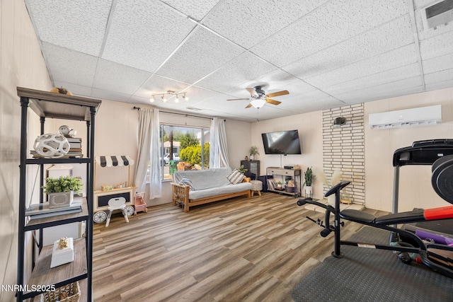 1712 Chaska Pl, Reno, NV 89502 - exercise room featuring an AC wall unit, a drop ceiling, a ceiling fan, and wood finished floors