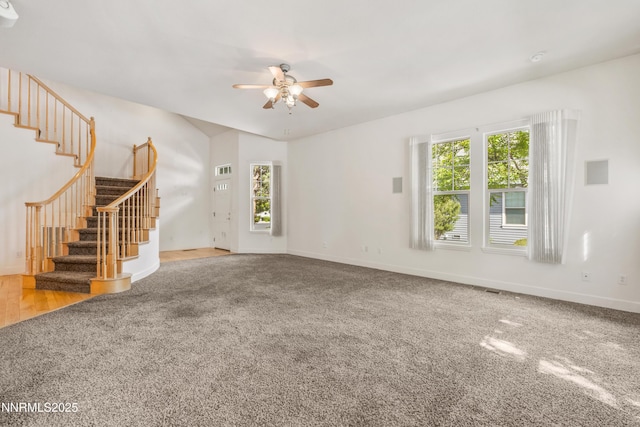 6638 Aston Cir, Sparks, NV 89436 - unfurnished living room featuring carpet flooring, ceiling fan, stairs, and healthy amount of natural light