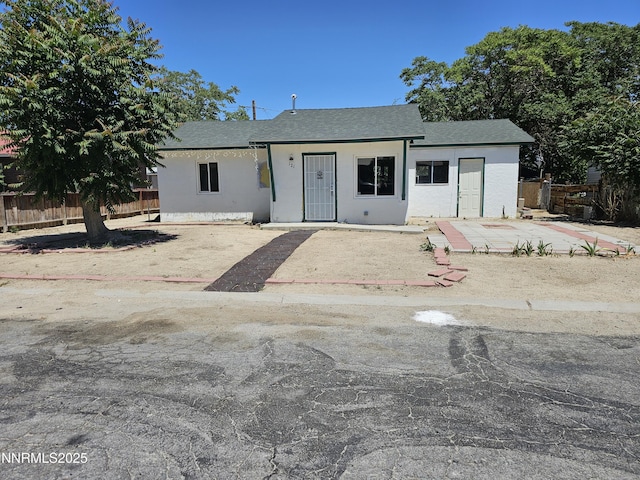 121 English St, Hawthorne, NV 89415 - view of front of house with a shingled roof, stucco siding, and a patio