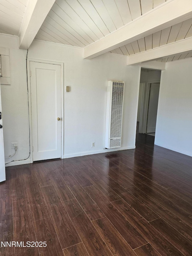 121 English St, Hawthorne, NV 89415 - spare room featuring a heating unit, dark wood-style floors, wooden ceiling with exposed beams, and baseboards