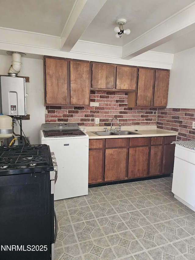 121 English St, Hawthorne, NV 89415 - kitchen featuring washer / dryer, a sink, gas range, light countertops, and beam ceiling