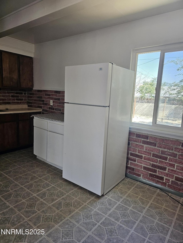 121 English St, Hawthorne, NV 89415 - kitchen with freestanding refrigerator and backsplash