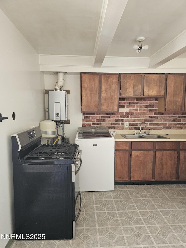 121 English St, Hawthorne, NV 89415 - kitchen with washer / clothes dryer, stainless steel gas range oven, a sink, tankless water heater, and crown molding
