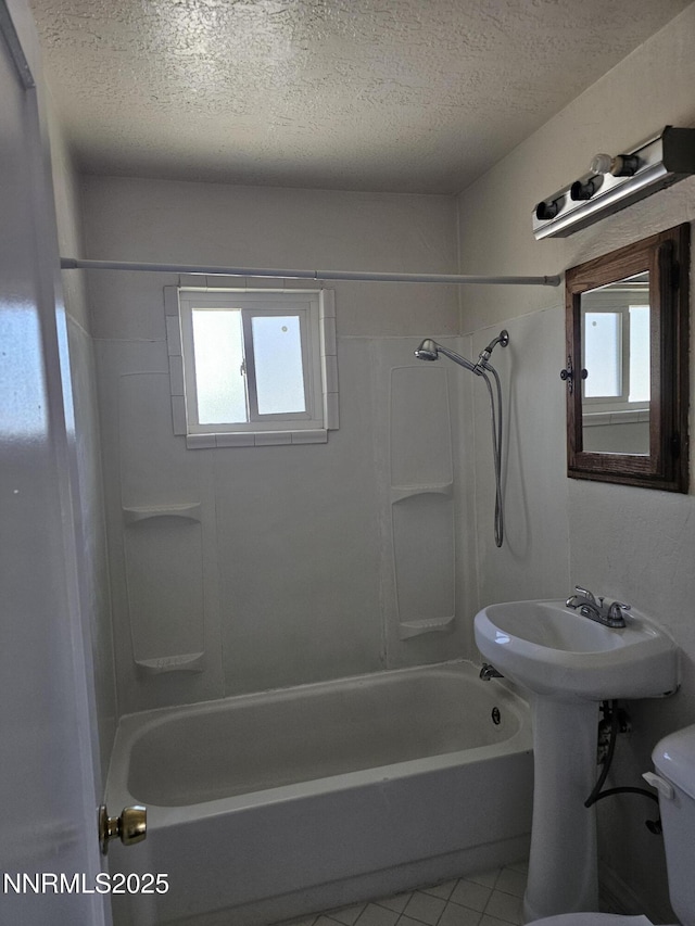 121 English St, Hawthorne, NV 89415 - full bathroom with shower / tub combination, a textured ceiling, plenty of natural light, tile patterned flooring, and toilet