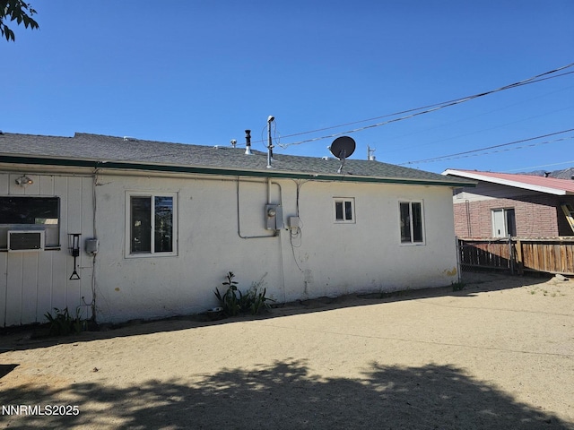 121 English St, Hawthorne, NV 89415 - view of side of home with stucco siding and a shingled roof