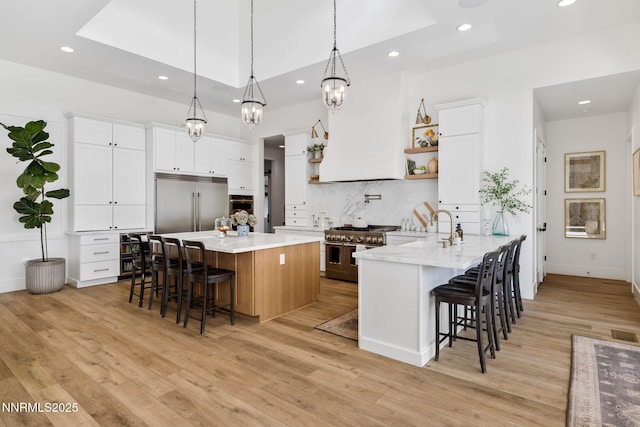 6300 Trailblazer Ct, Reno, NV 89511 - kitchen with high end appliances, a breakfast bar area, recessed lighting, open shelves, and white cabinetry