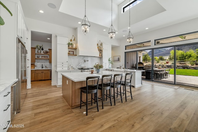 6300 Trailblazer Ct, Reno, NV 89511 - kitchen featuring open shelves, light wood finished floors, decorative backsplash, white cabinets, and recessed lighting