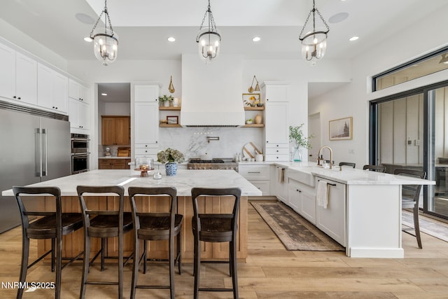 6300 Trailblazer Ct, Reno, NV 89511 - kitchen featuring open shelves, a sink, appliances with stainless steel finishes, a kitchen bar, and recessed lighting