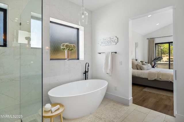 6300 Trailblazer Ct, Reno, NV 89511 - bathroom featuring ensuite bathroom, a freestanding bath, marble look tile flooring, walk in shower, and lofted ceiling