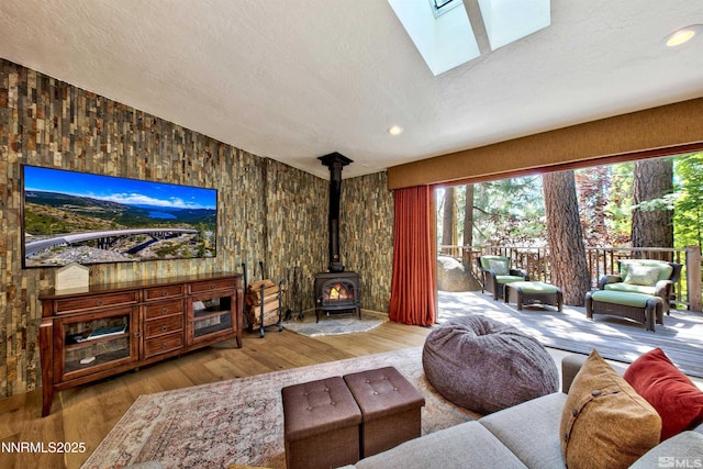 259 Mc Faul Ct, Zephyr Cove, NV 89448 - living room with wood finished floors, a wood stove, a textured ceiling, recessed lighting, and a skylight
