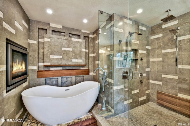 259 Mc Faul Ct, Zephyr Cove, NV 89448 - full bath with a soaking tub, a stall shower, tile walls, and recessed lighting