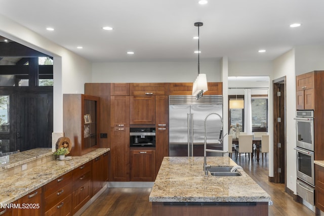235 Timbercreek Ct, Reno, NV 89511 - kitchen featuring appliances with stainless steel finishes, dark wood finished floors, a warming drawer, a sink, and light stone counters