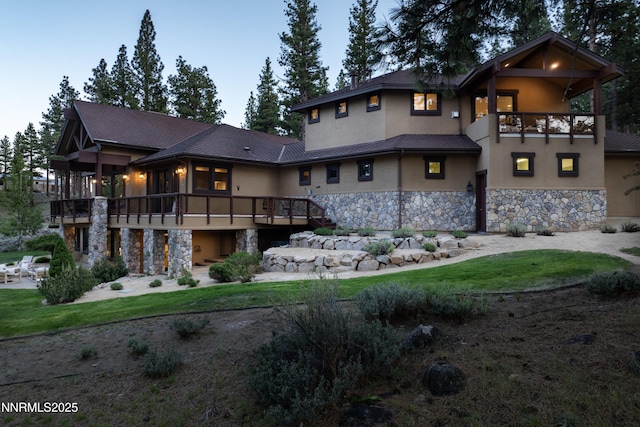 235 Timbercreek Ct, Reno, NV 89511 - back of property featuring stone siding, stucco siding, and a balcony