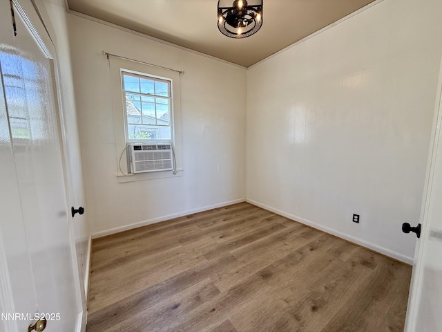 141 University St, Tonopah, NV 89049 - unfurnished room with wood finished floors, cooling unit, a chandelier, and baseboards