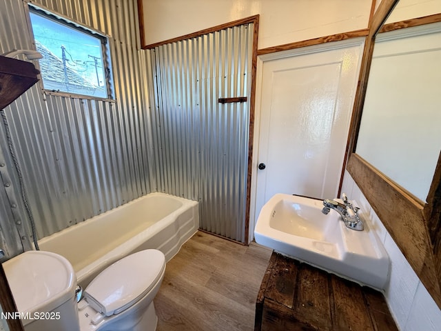 141 University St, Tonopah, NV 89049 - full bath with toilet, wood finished floors, a sink, and shower / washtub combination