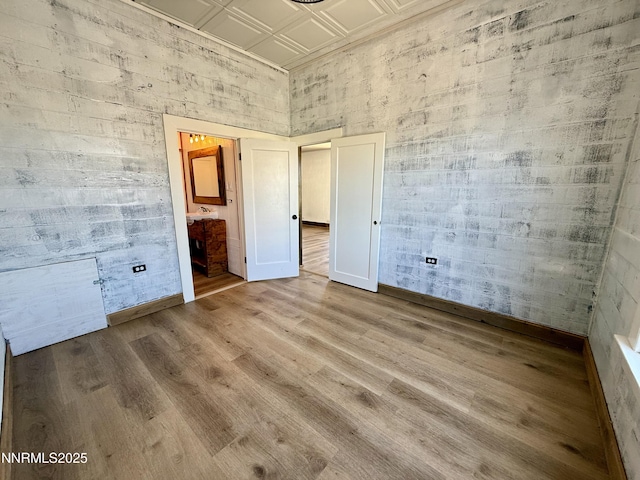 141 University St, Tonopah, NV 89049 - unfurnished bedroom with wood finished floors, an ornate ceiling, and ensuite bathroom