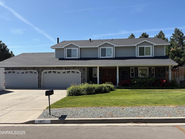 1885 Yale Dr, Carson City, NV 89703 - traditional-style house featuring concrete driveway, stone siding, a front lawn, a garage, and a shingled roof