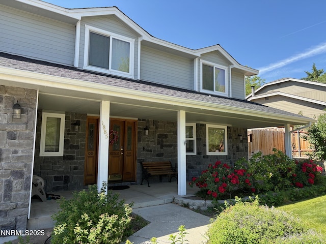 1885 Yale Dr, Carson City, NV 89703 - view of front of property with stone siding, covered porch, and roof with shingles