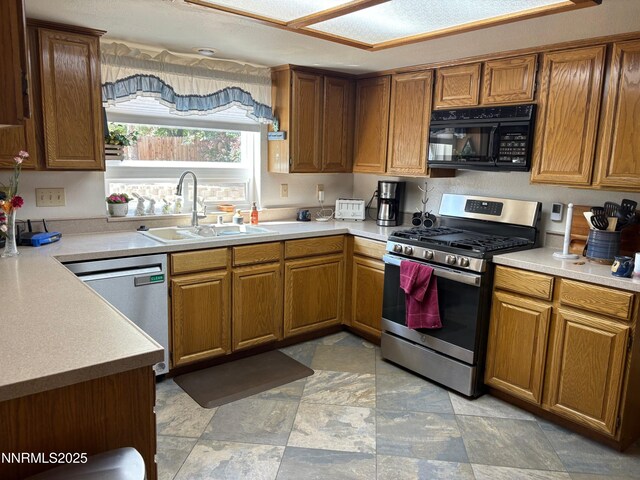 1885 Yale Dr, Carson City, NV 89703 - kitchen with appliances with stainless steel finishes, a sink, light countertops, and brown cabinetry