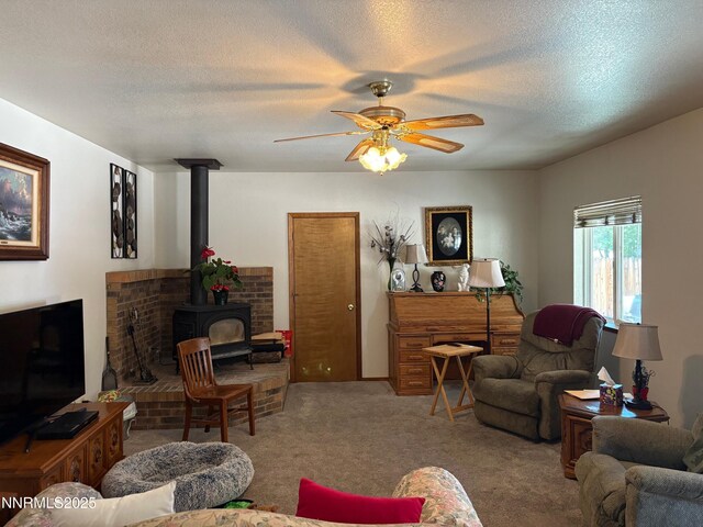 1885 Yale Dr, Carson City, NV 89703 - living room with a wood stove, carpet floors, a ceiling fan, and a textured ceiling