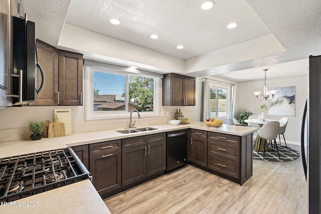 84 Arndell Way, Sparks, NV 89431 - kitchen featuring dishwashing machine, a sink, freestanding refrigerator, dark brown cabinets, and a peninsula