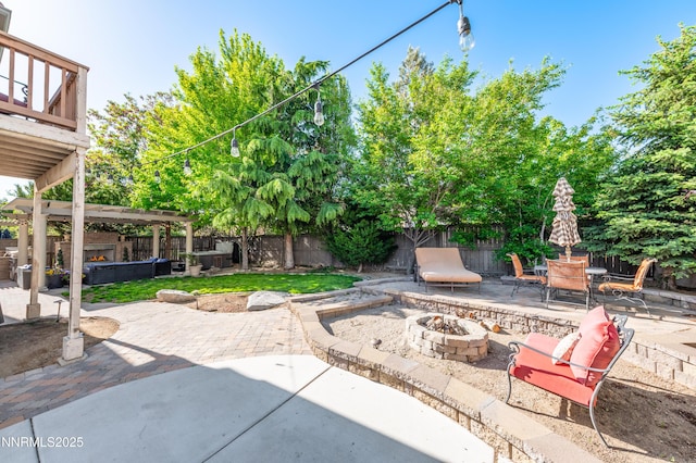 471 Shire Ct, Reno, NV 89521 - fenced backyard featuring an outdoor fire pit, a patio area, and a jacuzzi