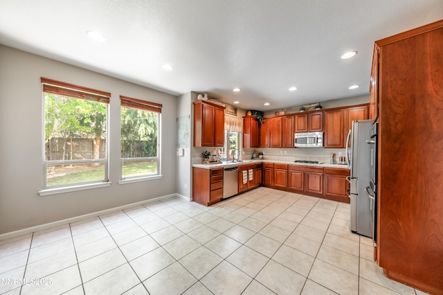 471 Shire Ct, Reno, NV 89521 - kitchen featuring stainless steel appliances, light countertops, recessed lighting, baseboards, and brown cabinets