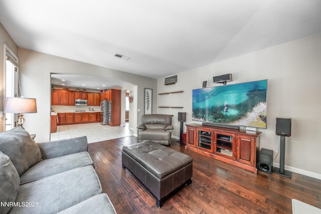 471 Shire Ct, Reno, NV 89521 - living room with baseboards, light wood finished floors, and arched walkways