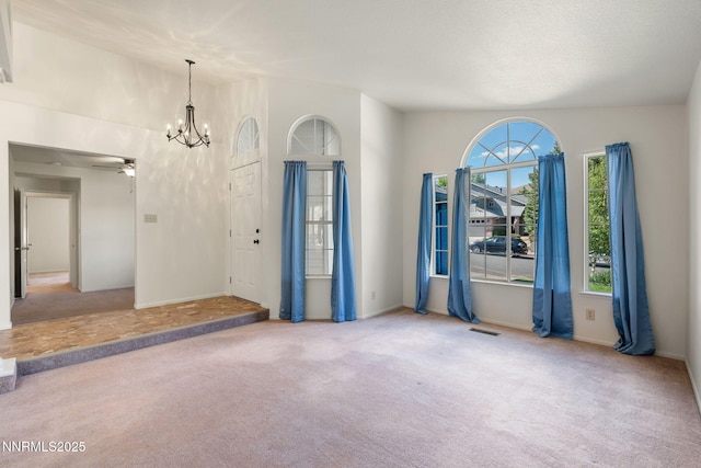 6649 Valley Wood Dr, Reno, NV 89523 - carpeted empty room with a chandelier, a ceiling fan, and baseboards