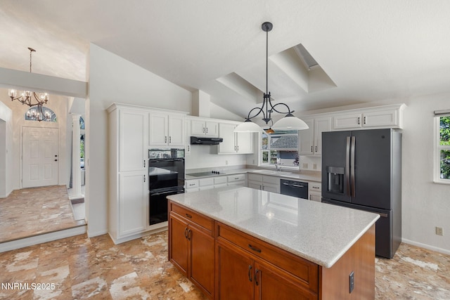 6649 Valley Wood Dr, Reno, NV 89523 - kitchen with black appliances, under cabinet range hood, a chandelier, a kitchen island, and light stone counters