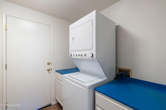 6649 Valley Wood Dr, Reno, NV 89523 - laundry area with estacked washer and dryer, cabinet space, and wood finished floors