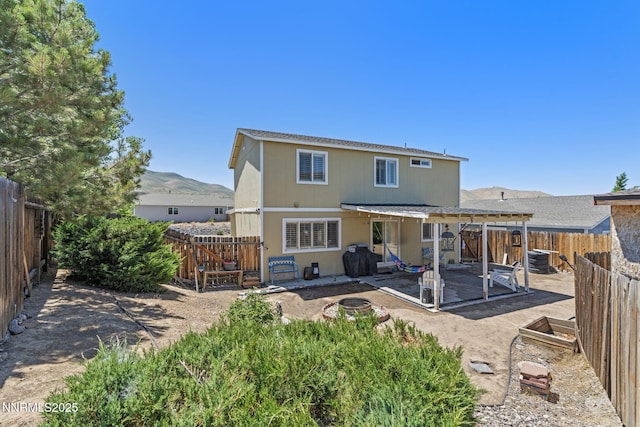 7991 Mariner Cove Dr, Reno, NV 89506 - rear view of house featuring a patio area, a mountain view, and a fenced backyard