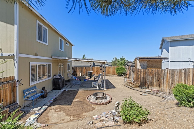 7991 Mariner Cove Dr, Reno, NV 89506 - fenced backyard with an outdoor fire pit and a patio area