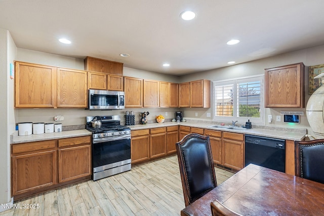 7991 Mariner Cove Dr, Reno, NV 89506 - kitchen featuring appliances with stainless steel finishes, recessed lighting, light wood-style floors, light countertops, and brown cabinetry