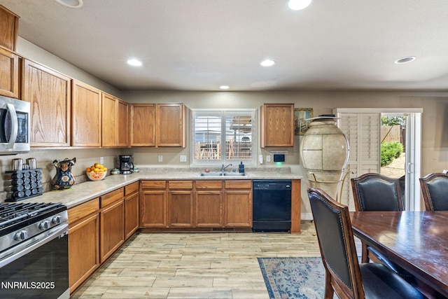 7991 Mariner Cove Dr, Reno, NV 89506 - kitchen featuring appliances with stainless steel finishes, light countertops, light wood-style flooring, healthy amount of natural light, and recessed lighting