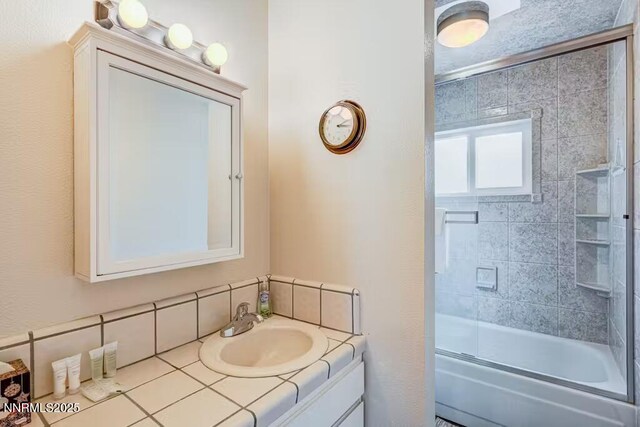 801 Northwood Blvd Unit 10, Incline Village, NV 89451 - bathroom featuring vanity and combined bath / shower with glass door