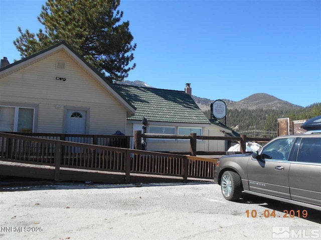 11000 Mount Rose Hwy, Reno, NV 89511 - view of front of house with a chimney, a mountain view, and a tiled roof