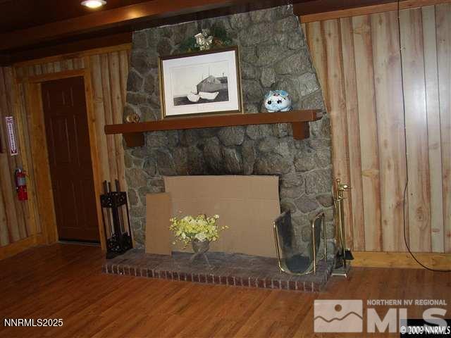 11000 Mount Rose Hwy, Reno, NV 89511 - detailed view of a large fireplace, wood finished floors, and wooden walls