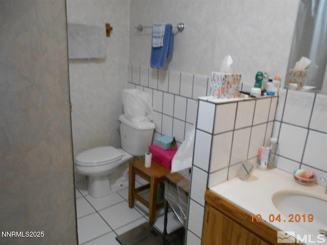 11000 Mount Rose Hwy, Reno, NV 89511 - bathroom featuring vanity, tile patterned floors, decorative backsplash, and tile walls
