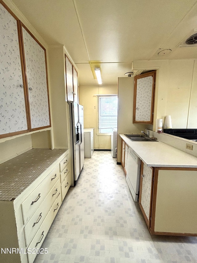 831 N 1st St, Battle Mountain, NV 89820 - kitchen featuring fridge with ice dispenser, white dishwasher, a sink, and washer and dryer