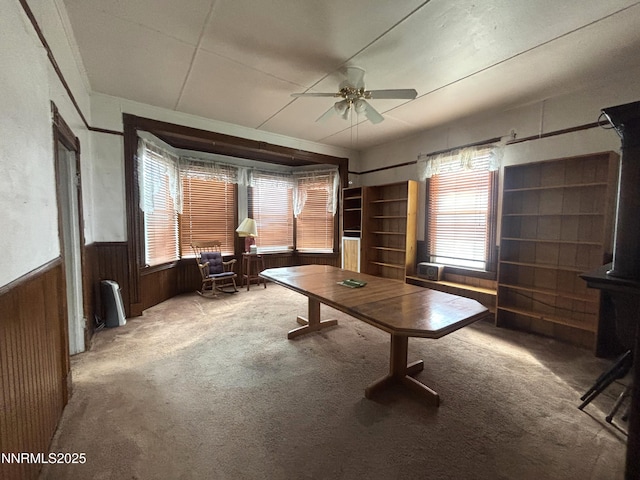 831 N 1st St, Battle Mountain, NV 89820 - home office with a wainscoted wall, healthy amount of natural light, a ceiling fan, carpet floors, and wooden walls