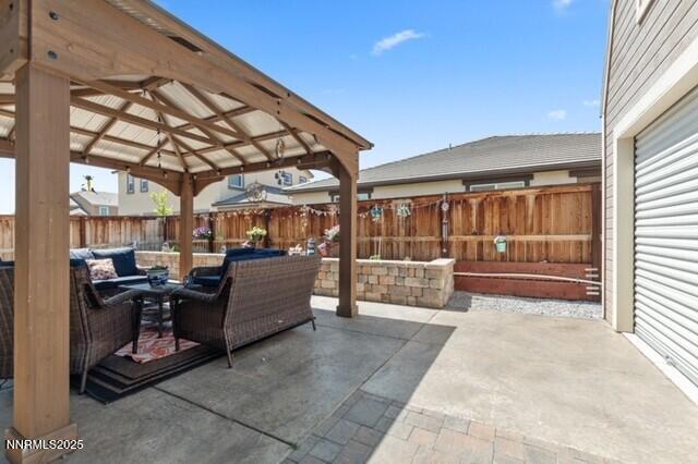 6127 Red Stable Rd, Sparks, NV 89436 - fenced backyard featuring a gazebo, a patio, and an outdoor hangout area
