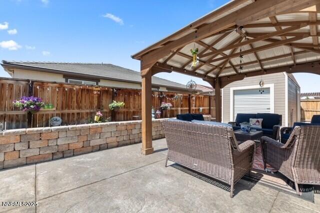 6127 Red Stable Rd, Sparks, NV 89436 - fenced backyard featuring outdoor lounge area, a patio area, and a gazebo