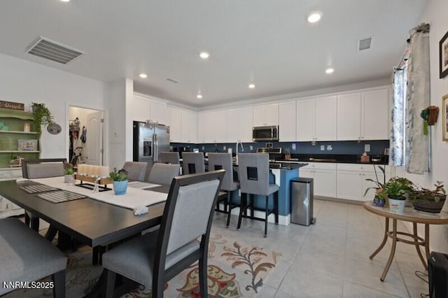 6127 Red Stable Rd, Sparks, NV 89436 - dining area with light tile patterned flooring and recessed lighting
