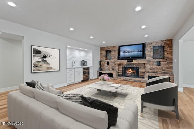 2080 Del Rio Ln, Reno, NV 89509 - living room with wine cooler, light wood finished floors, baseboards, a fireplace, and recessed lighting