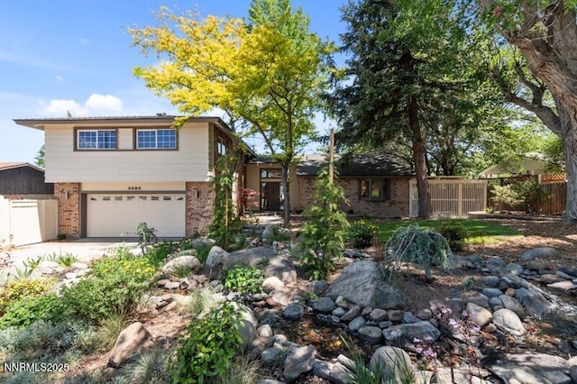 2080 Del Rio Ln, Reno, NV 89509 - view of front of property featuring brick siding, a garage, and driveway