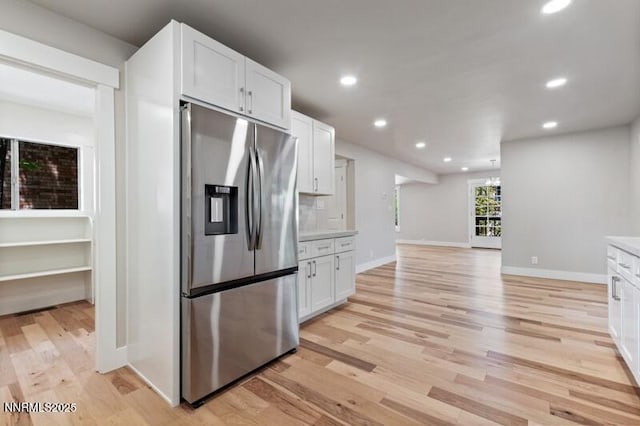 2080 Del Rio Ln, Reno, NV 89509 - kitchen with stainless steel fridge, light wood-style floors, white cabinets, recessed lighting, and light countertops