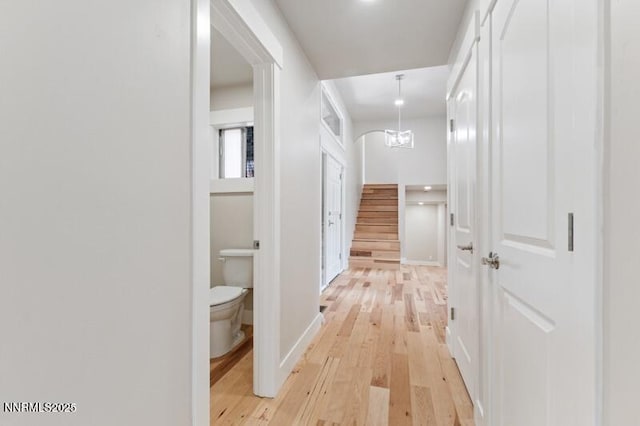 2080 Del Rio Ln, Reno, NV 89509 - hall featuring light wood finished floors, stairway, and baseboards