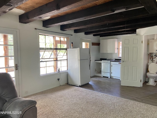 285 Main St, Silver City, NV 89428 - unfurnished living room featuring water heater, beamed ceiling, healthy amount of natural light, and carpet